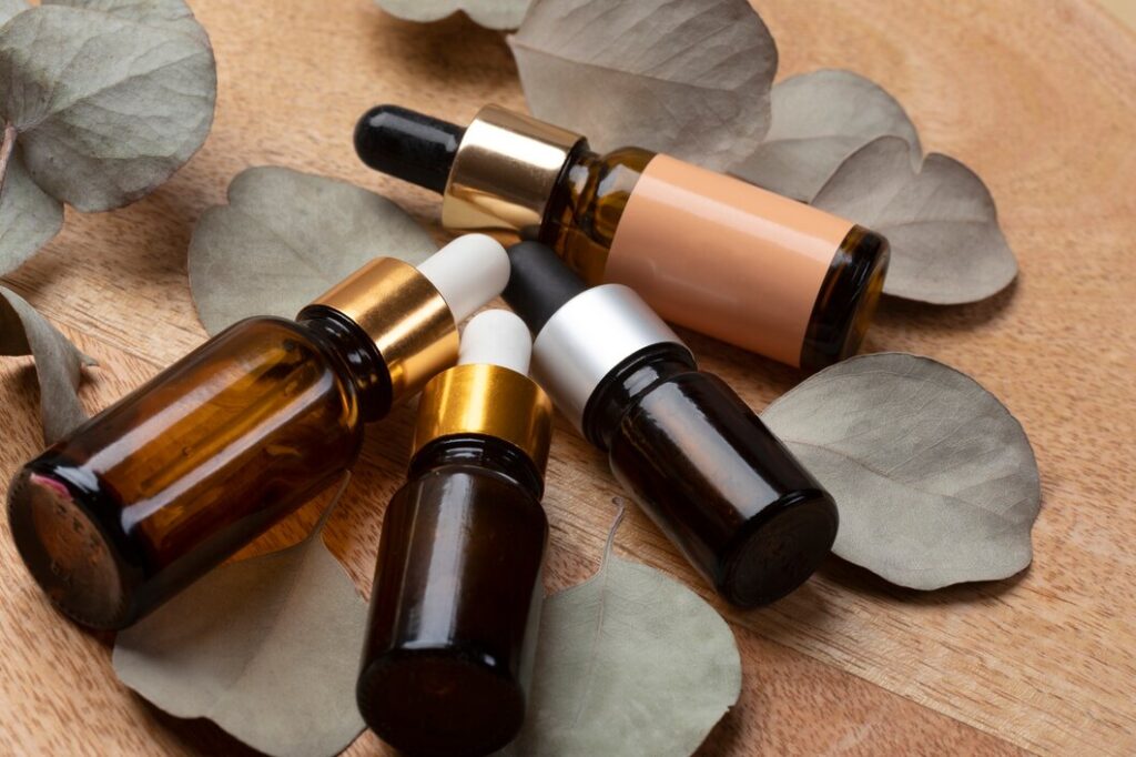 bottles of essential oils in varying sizes and colors arranged