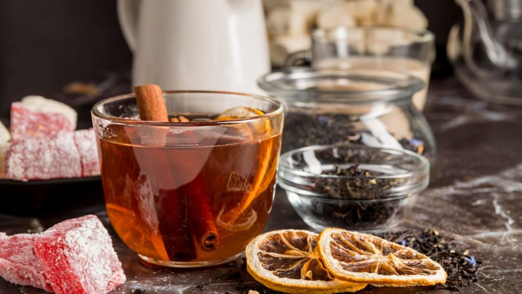glass of spiced tea with cinnamon and dried orange slices