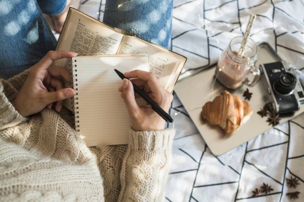 cozy scene of a person in a knitted sweater writing
