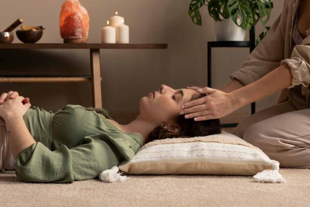 person lies on a soft pillow, while another gently touches their head