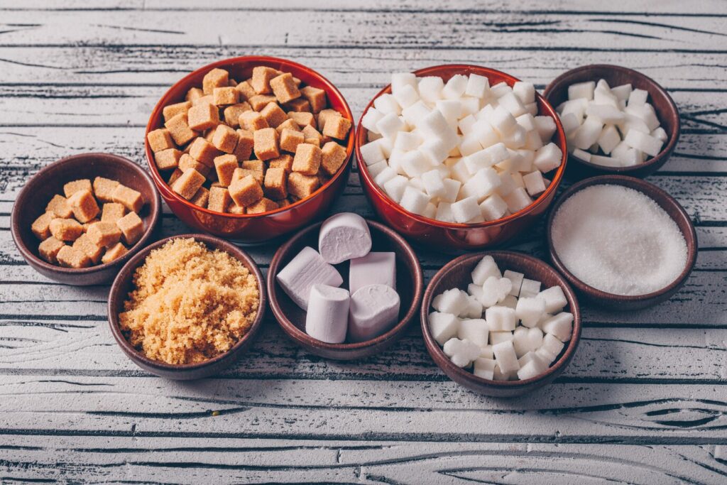 Set of marshmallow and white and brown sugar in bowls