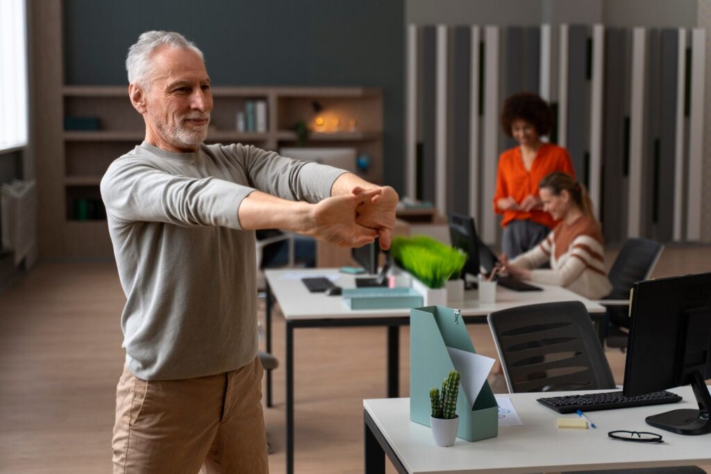 man stretches his arms in a modern office